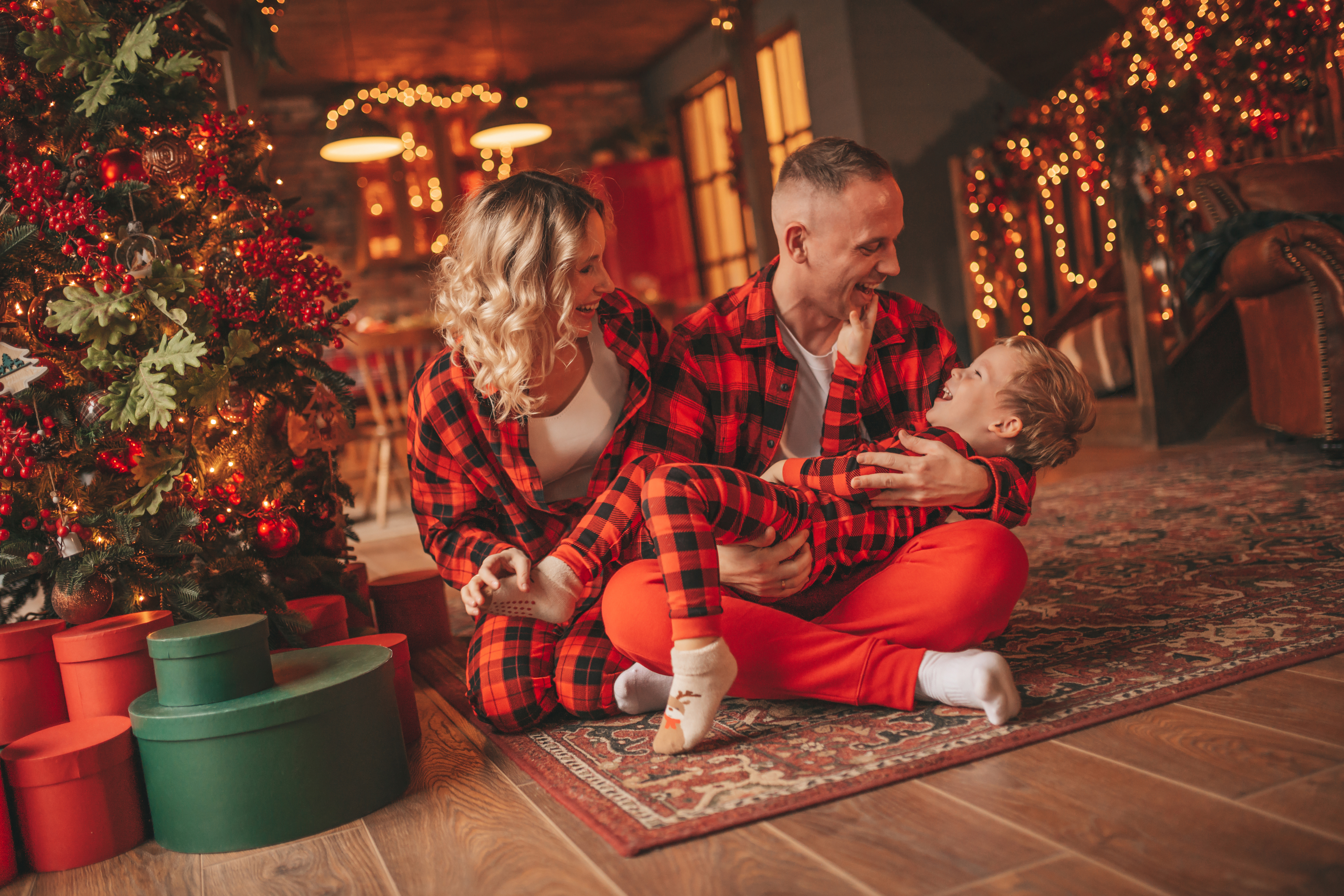 candid-authentic-cute-happy-family-red-plaid-pajamas-spends-time-together-lodge-xmas-decorated